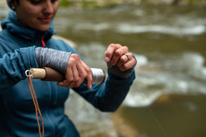 Woman reeling a handline fishing reel