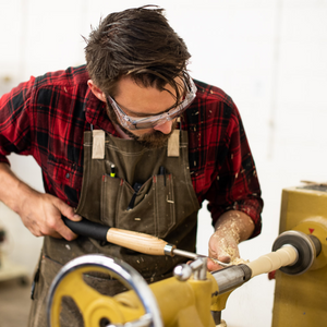 Turning Daggerfish hand line fishing reel prototypes on lathe in workshop
