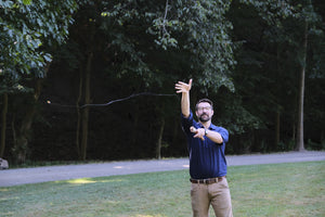 Man demonstrating how to perform a lasso cast with a handline fishing reel, simple fishing gear for backpack fishing